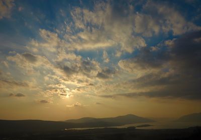 Scenic view of silhouette mountains against sky at sunset