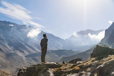 Man standing on mountain against sky