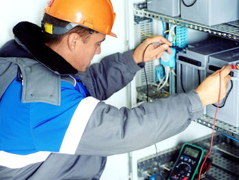 Midsection of man working in factory