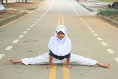 Portrait of smiling girl on road