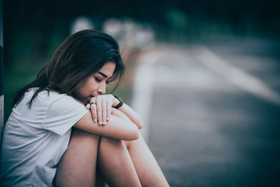 Young woman sitting outdoors