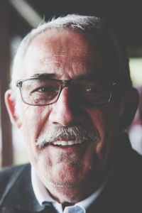 Close-up portrait of senior man wearing eyeglasses