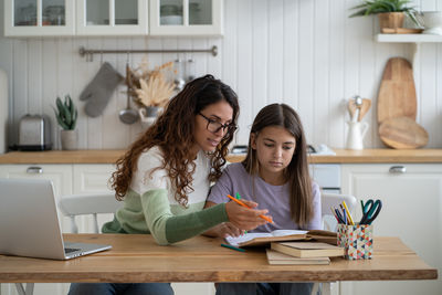 Young woman using laptop at table