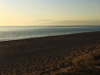 Scenic view of sea against clear sky during sunset