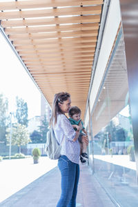 Full length of woman standing on bridge