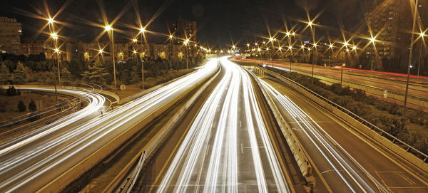 High angle view of light trails on highway at night