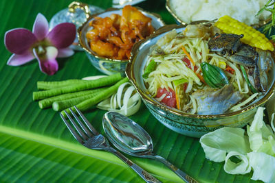 Close-up of green papaya salad or som tam with black crab and fresh shrimp and pickled fish