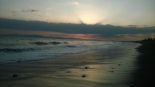 Scenic view of beach against sky during sunset