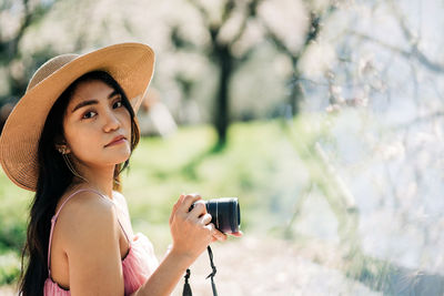 Portrait of young woman wearing hat