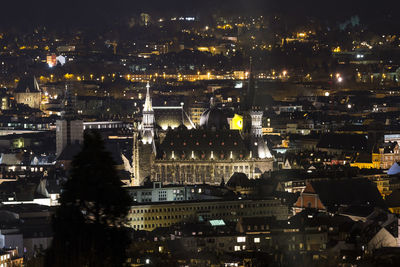 Aerial view of city lit up at night