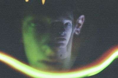 Close-up of illuminated light bulbs seen through glass