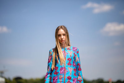 Portrait of woman standing against sky