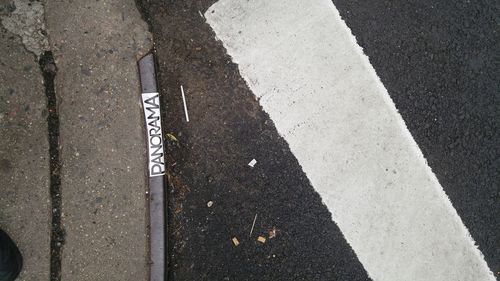 High angle view of text on sidewalk by street