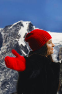 Midsection of woman in red hat