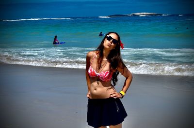 Young woman standing at beach