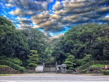 Houses against cloudy sky