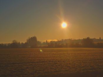 Scenic view of field against sky during sunset