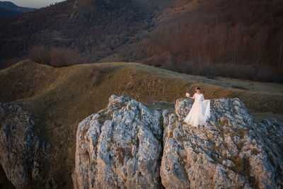 High angle view of people standing on rocks