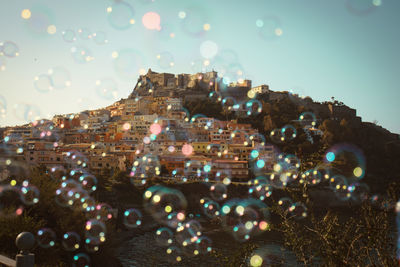 Panoramic view of illuminated city buildings against clear sky