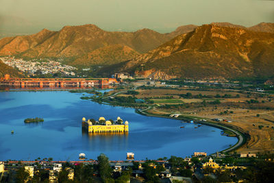 High angle view of jal mahal in lake against mountain during sunset