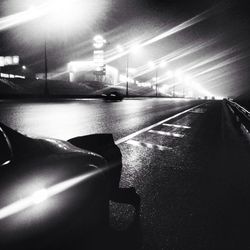 Road passing through illuminated tunnel