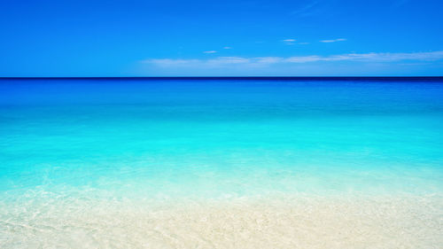 Scenic view of sea against blue sky