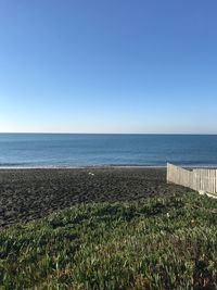 Scenic view of sea against clear blue sky