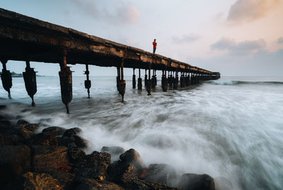 Pier over sea against sky