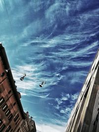 Low angle view of cloudy sky over city