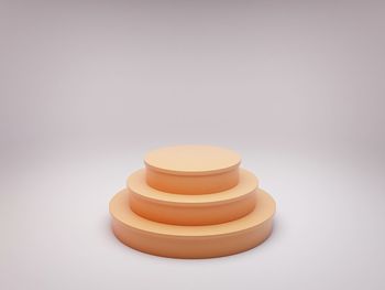 Close-up of stack on table against white background