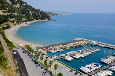 Aerial view of boats moored at harbor by sea