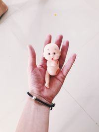 High angle view of hand holding toy