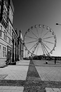 Ferris wheel against sky in city