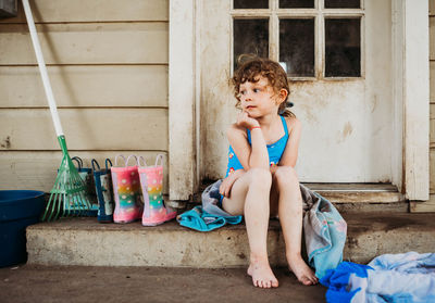 Full length of woman sitting outdoors