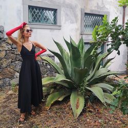 Woman standing by plants in yard