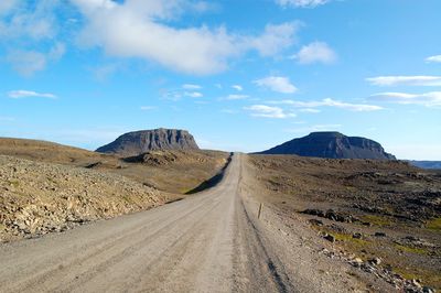 Scenic view of road amidst mountains against sky