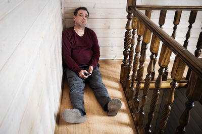 Portrait of man sitting on staircase