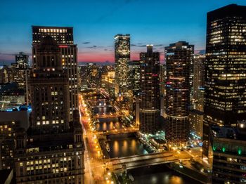 Aerial view of city lit up at night