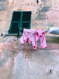 Low angle view of clothes drying against building