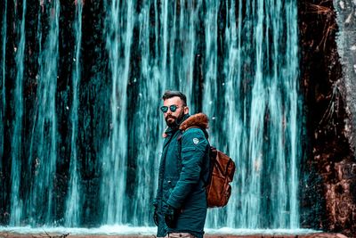 Man looking at waterfall