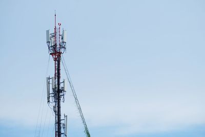 Low angle view of communications tower against sky