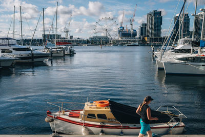 Boats in river against buildings