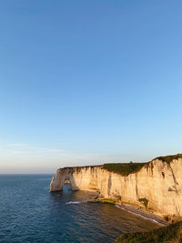 Scenic view of sea against clear blue sky sunset sunny day clear water surfing sunlight etretat 