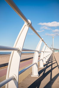 Low angle view of white railings on beach front