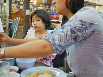 Mother and daughter at restaurant