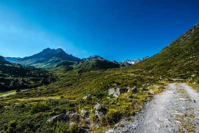 Scenic view of mountains against clear blue sky