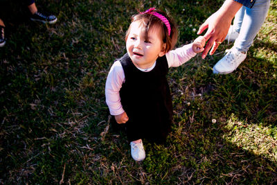 High angle view of girl standing on grass