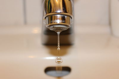 Close-up of water dripping from faucet on sink