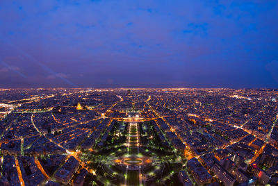 High angle view of illuminated cityscape against sky at night