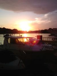 Boats in marina at sunset